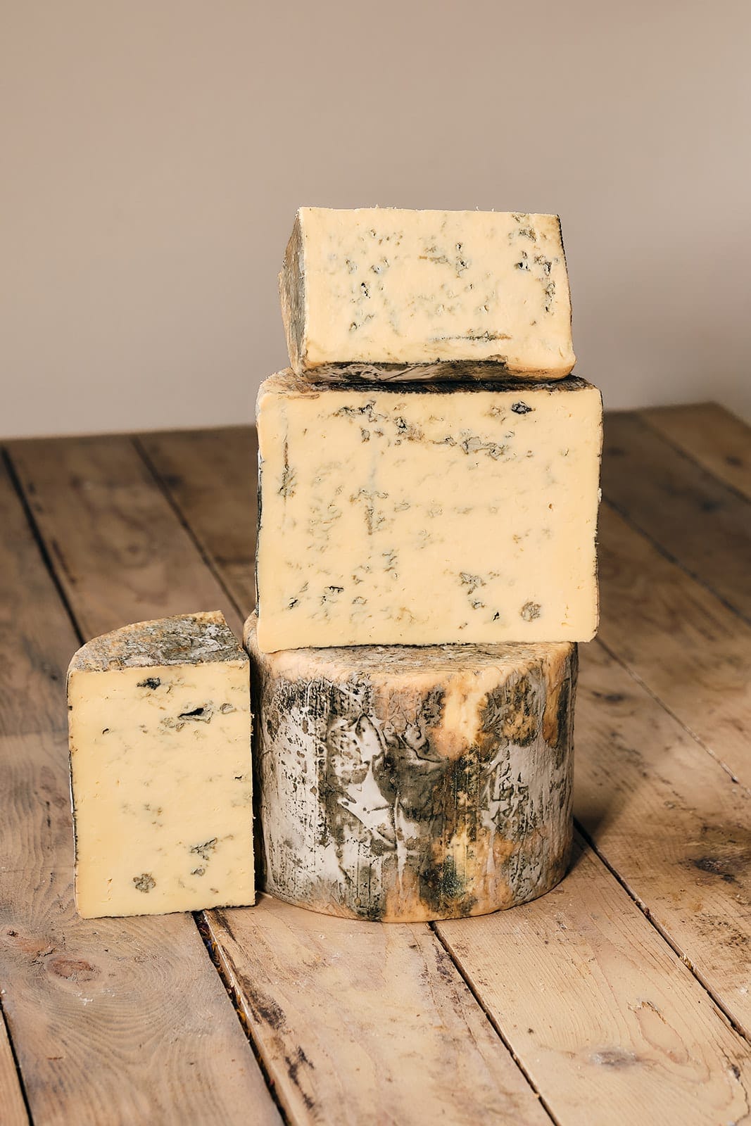 A wedge of farmhouse cheese on a marble counter